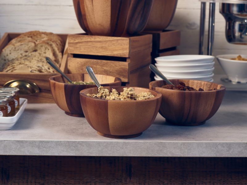 A collection of Acacia Wood Buffet Bowls on a breakfast buffet setting