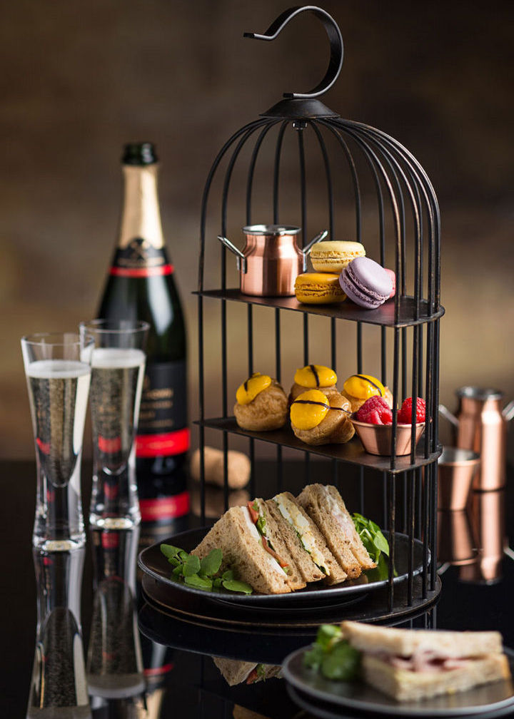 Birdcage Afternoon Tea Stand loaded with cakes and sandwiches
