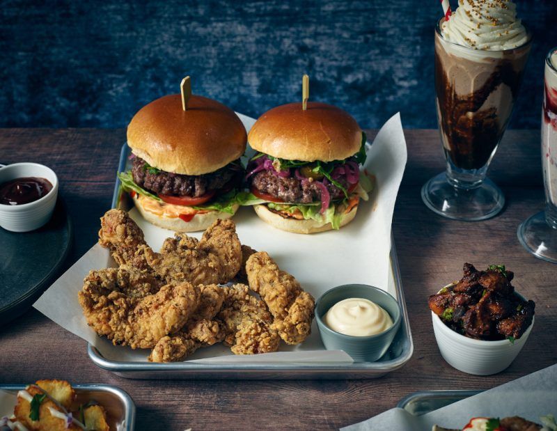 Food tray lined with white greaseproof paper and used to serve burgers