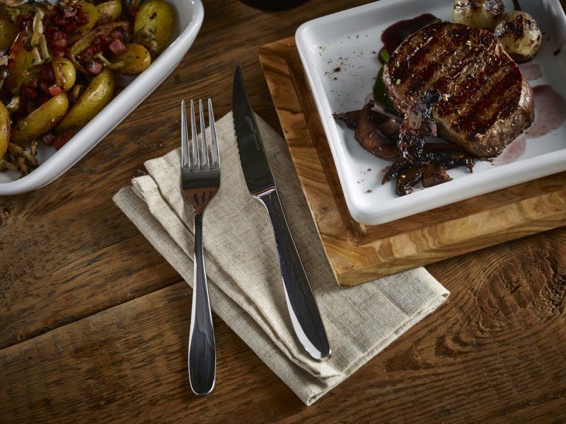 Lifestyle image of steak and Saffron Steak Knife