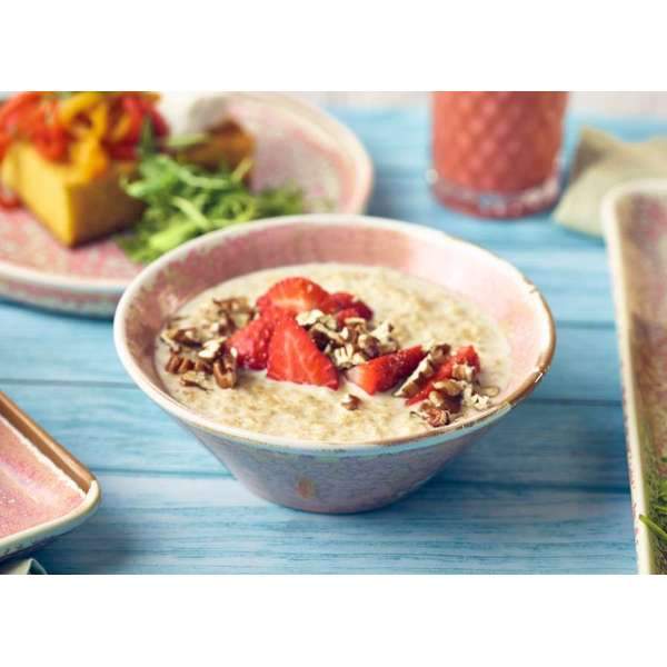 Rose terra conical bowl filled with porridge