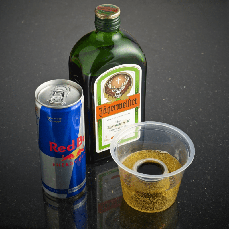 Bomb Shot Glass with can of Red Bull and bottle of Jaegermeister