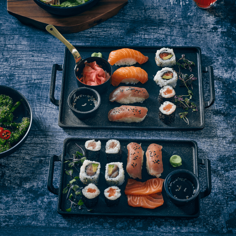 Sushi served on a rectangular cast iron platter