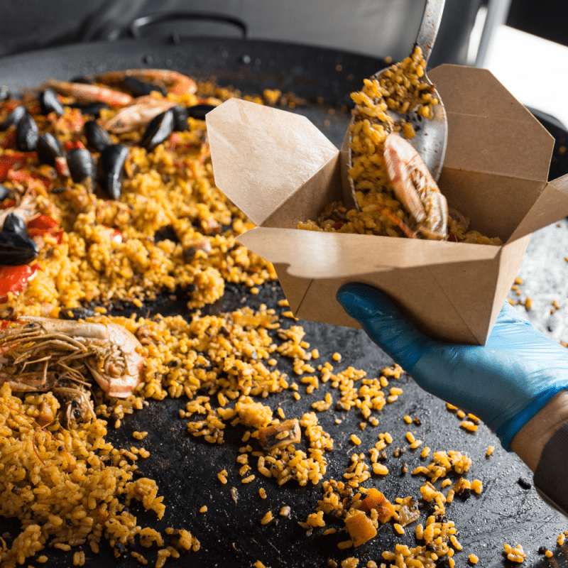 Lifestyle image of Paella being served into Kraft Deli Box