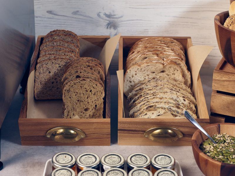 Acacia Wood Serving Drawers filled with slices of bread