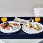 Black Butler Tray containing two hotel breakfast items.