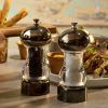 Lifestyle image of gun metal and acrylic salt and pepper grinders