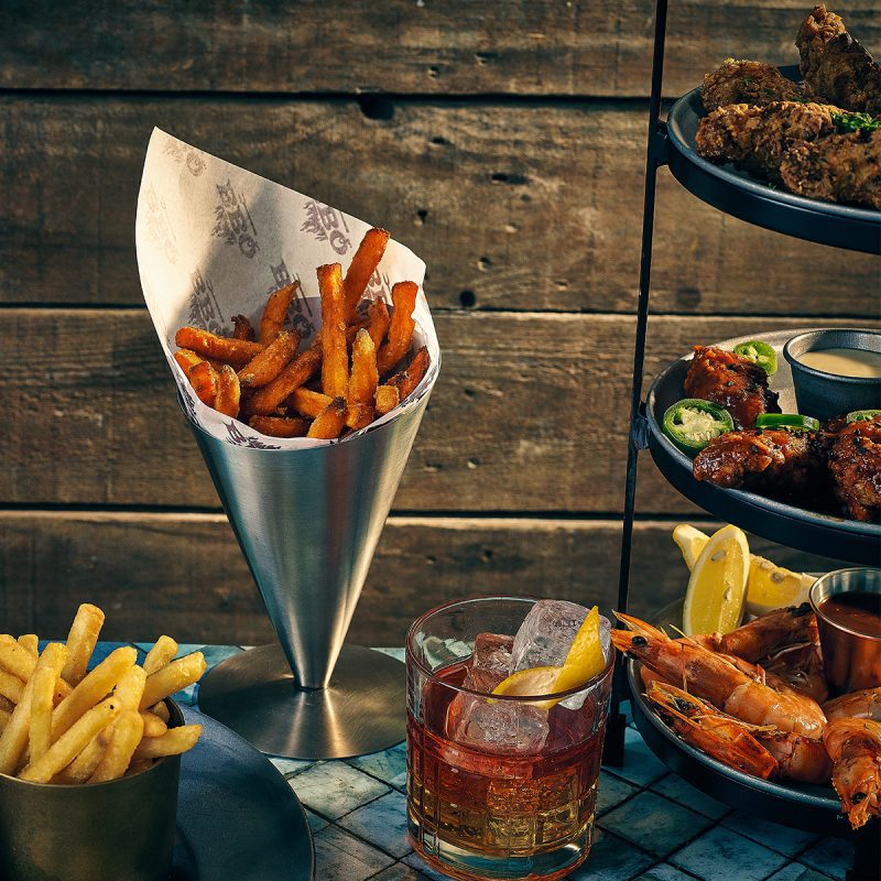Stainless steel serving cone with chips and greaseproof paper