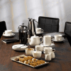 White porcelain beverage items including cream tots