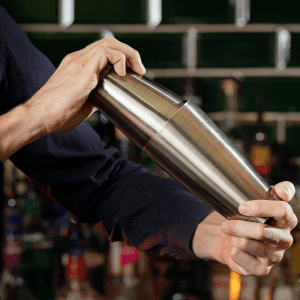 Lifstyle bartender shaking a Antique Brass Weighted Cocktail Shaker