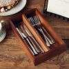 Lifestyle image of 2 compartment acacia wood cutlery tray complete with cutlery