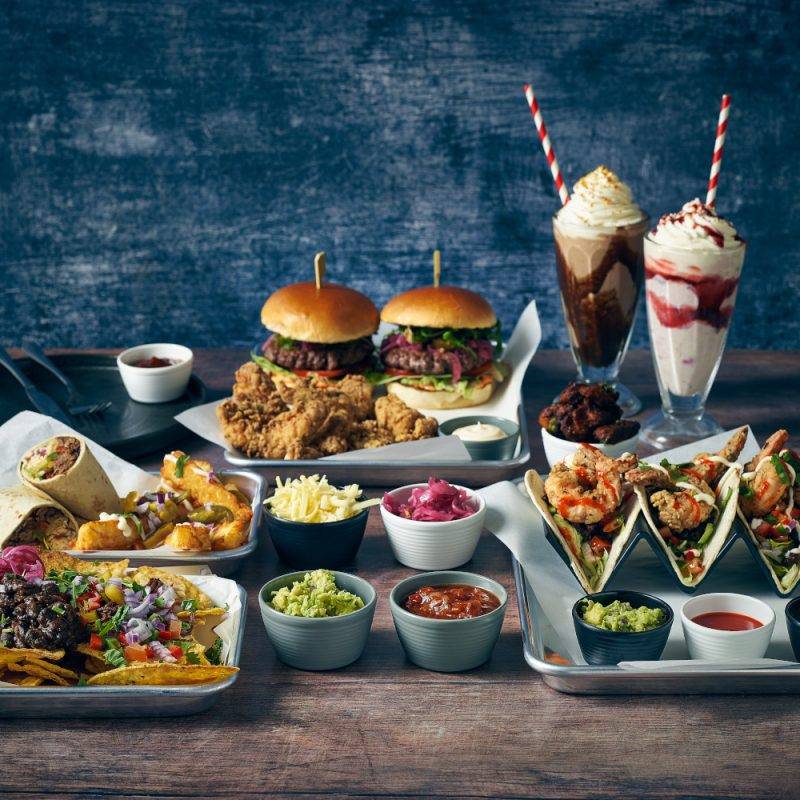 An array of mexican and American inspired food presented on Aluminium Bun Trays