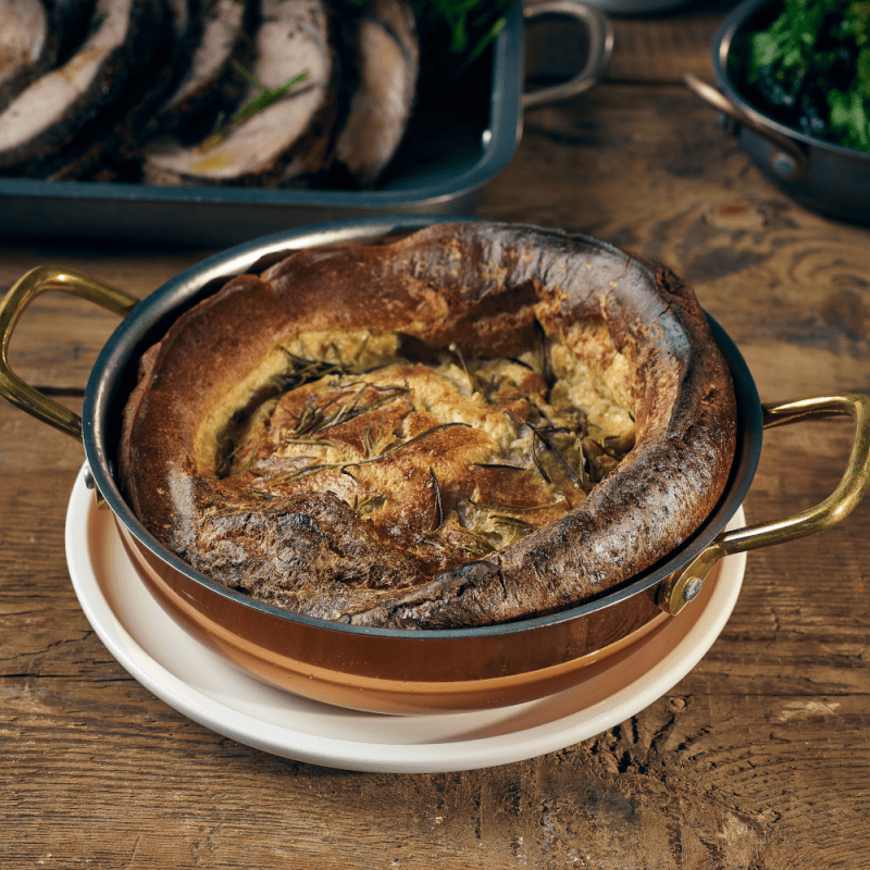 White porcelain plate with enormous Yorkshire Pudding