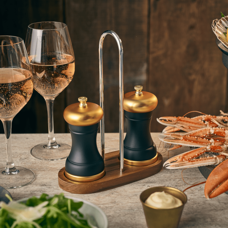 Acacia Wood Salt and Pepper Grinder Stand as part of a table setting