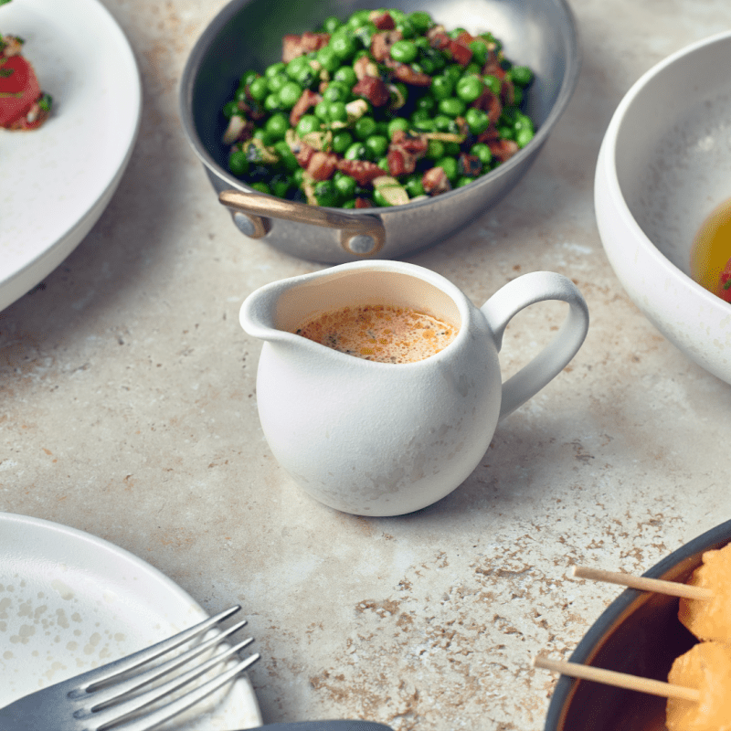 Sereno Porcelain Alto Jug with sauce on a dining table