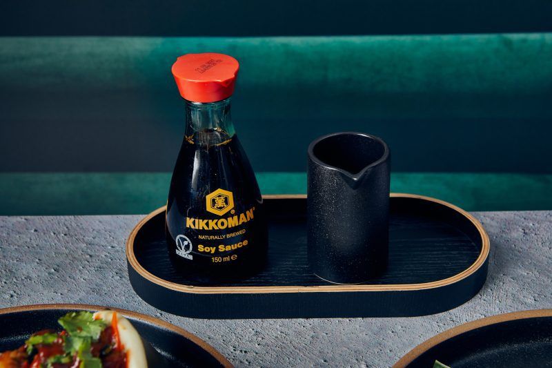 Soy Sauce and Jug displayed on an Oval Black Wood Veneer Tray