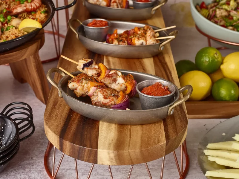 Buffet display of food with various risers and plinths