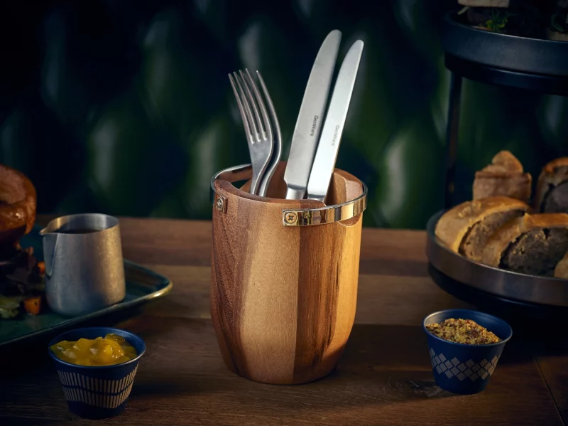 Table setting in a hospitality venue featuring acacia wood cutlery cylinder